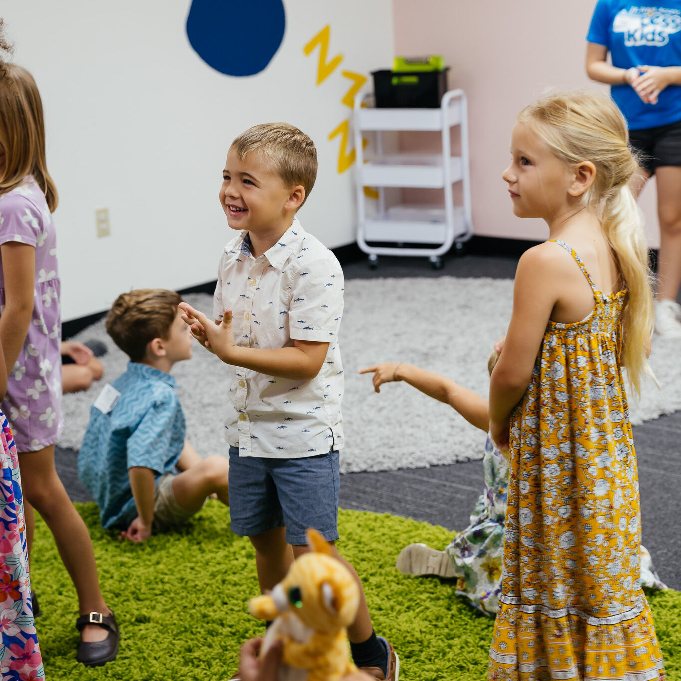 Woman sitting with child on rug